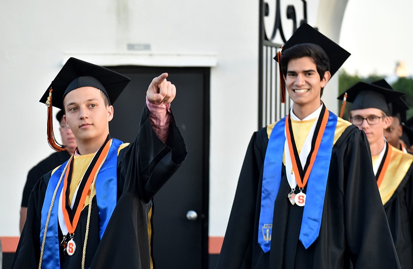 Graduates walk into Cleland Stadium.