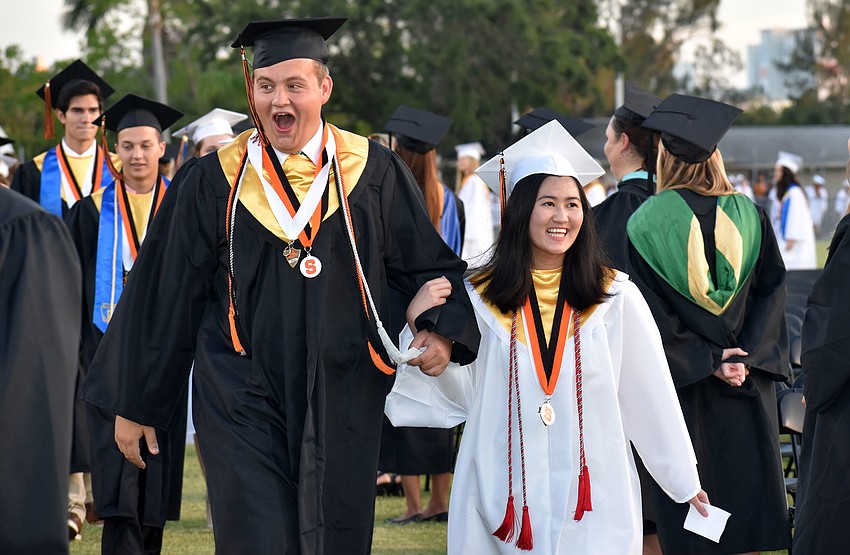 Graduates are all smiles as they arrive at Cleland Stadium.