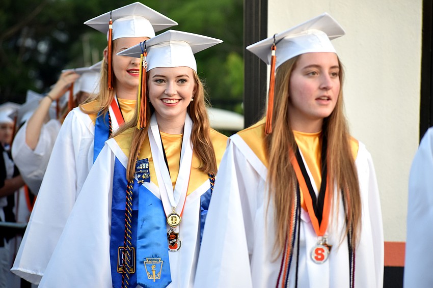 Graduates walk into Cleland Stadium.