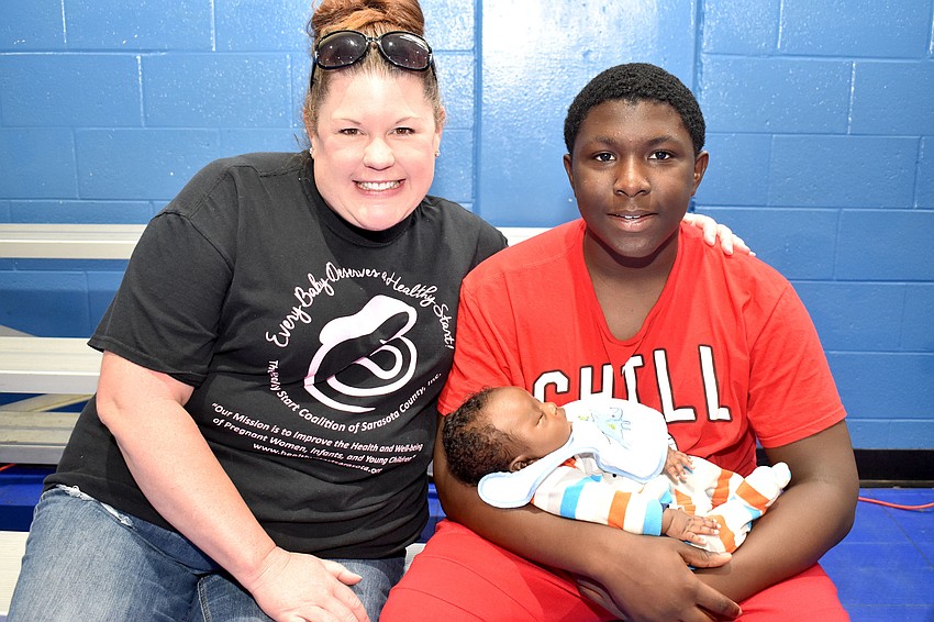 Healthy Start Coalition of Sarasota County Executive Director Shon Ewens and Mike and Elijah Theodore