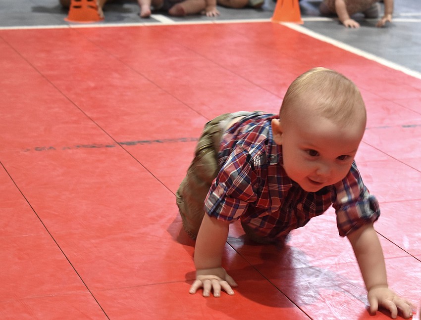Eliot Dalton crawls to his mom during the diaper derby. Dalton finished the short race first.