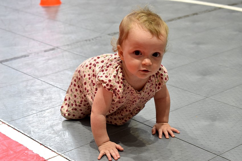 Diana Logvinova crawls around following the diaper derby.