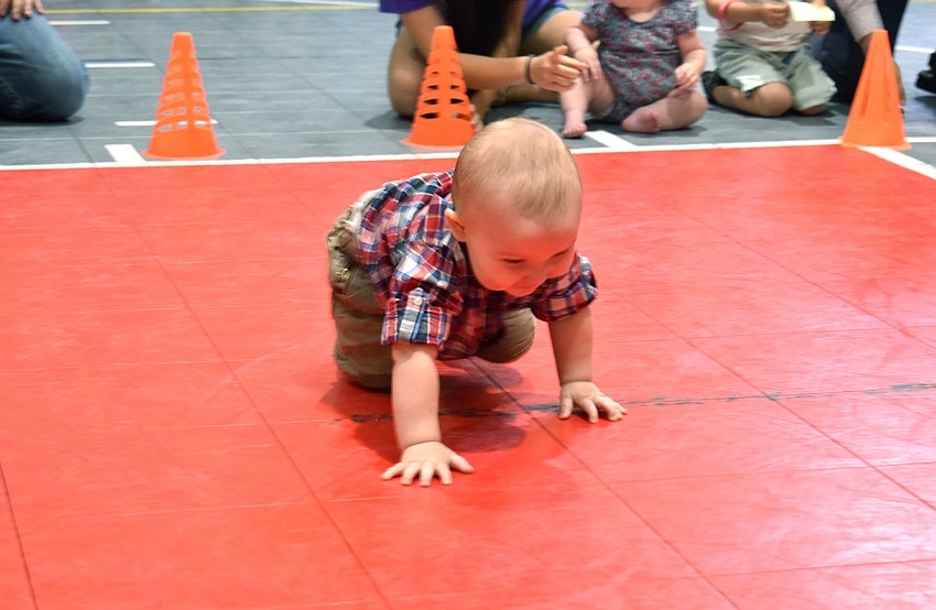 Eliot Dalton crawls to his mom during the diaper derby. Dalton finished the short race first.