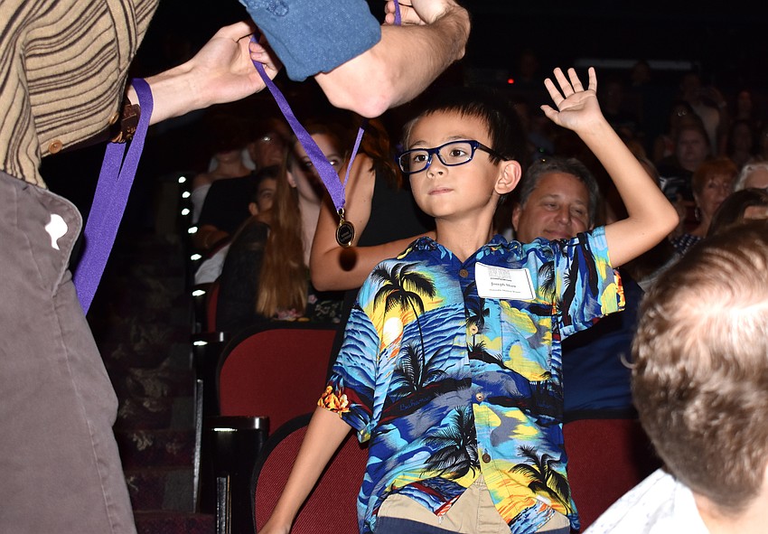 First Grader Joseph Shaw from Gulf Gate Elementary receives his honorable mention medal.