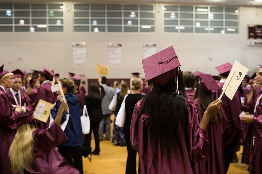The graduates patiently waited in lines.