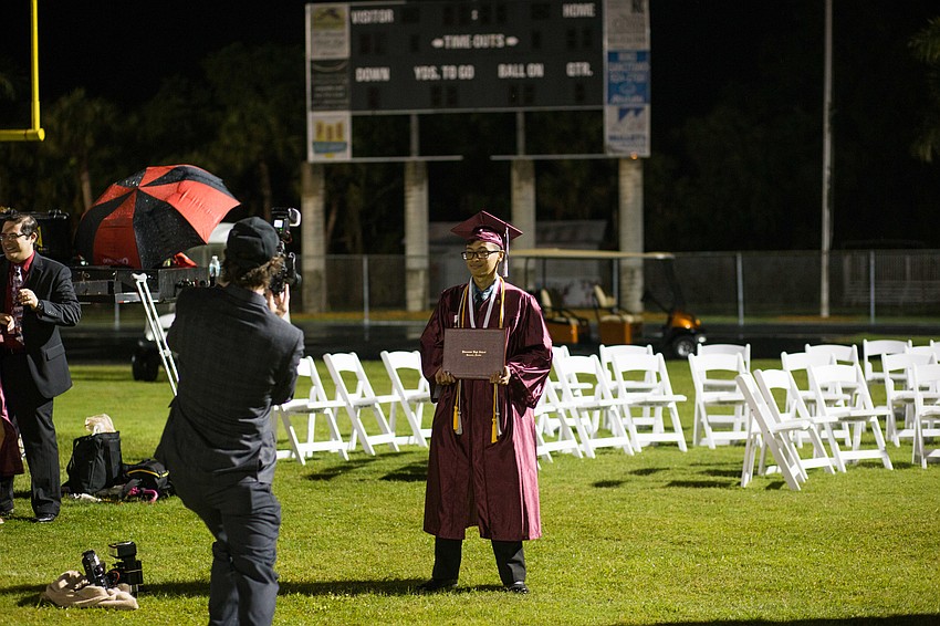 A student smiles for his graduation portrait.