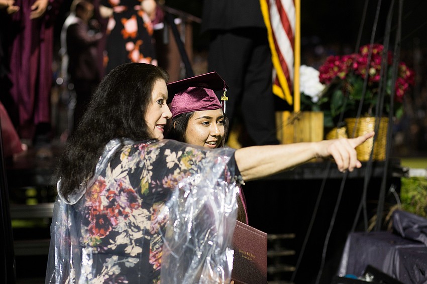 A faculty member shows the graduate where to go next.