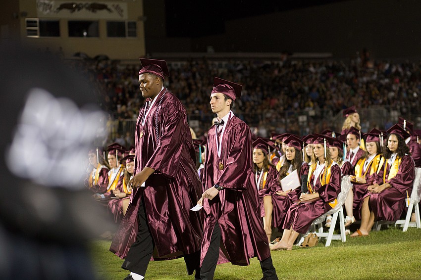 The graduates walked in pairs to the stage.