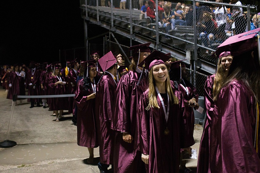 Students wait in line to walk the football field.