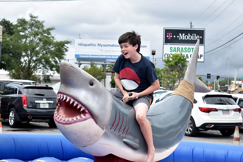 Nate Sutthoff takes a shot at riding the mechanical shark.