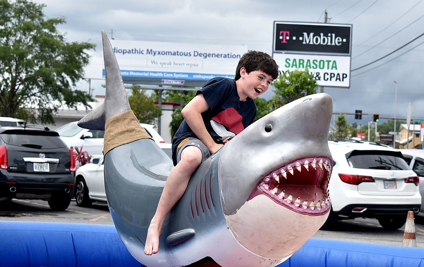 Nate Sutthoff takes a shot at riding the mechanical shark.