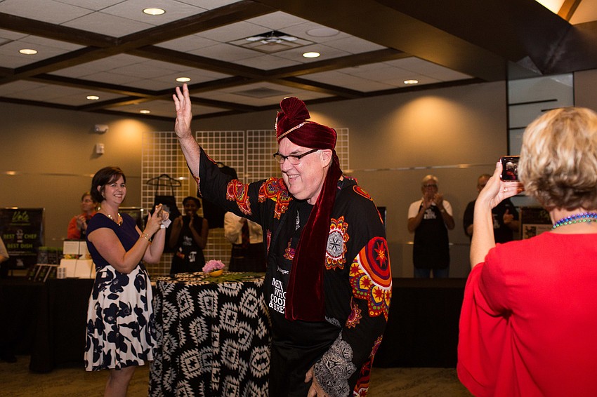 Jim Roque raises his hand as he's introduced.