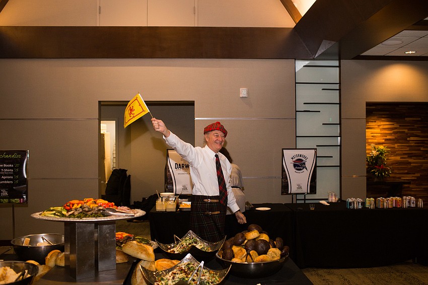 The only 8th year veteran, Gary Sweetman, waves a flag as he makes his way to his spot.