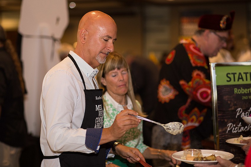 Robert Gaglio serves a guest his dish.