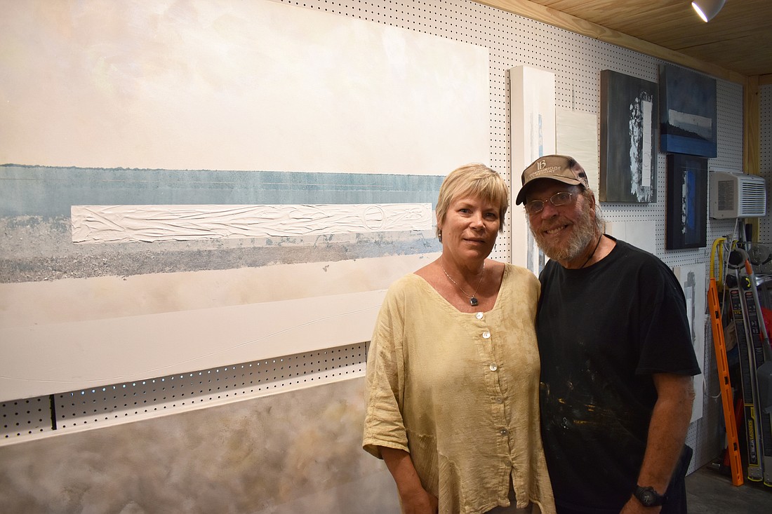 Michelle and Robert Casarietti channel their mutual passion for creating art and their unconditional love for each other into painting abstract pieces on the same canvas for every work they create. Photo by Niki Kottmann
