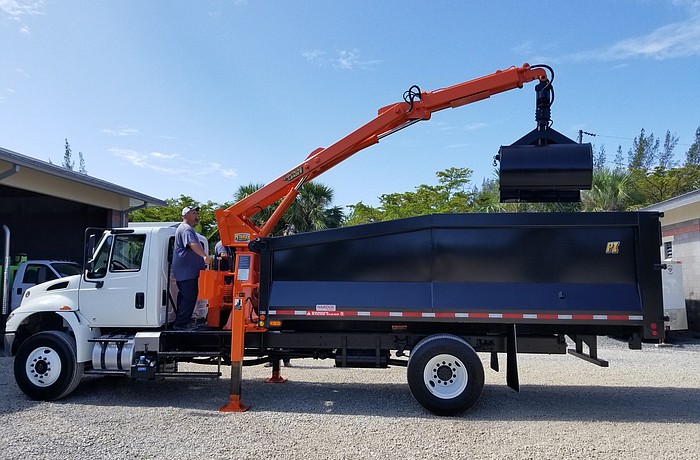 The grapple truck is designed to scoop up debris.