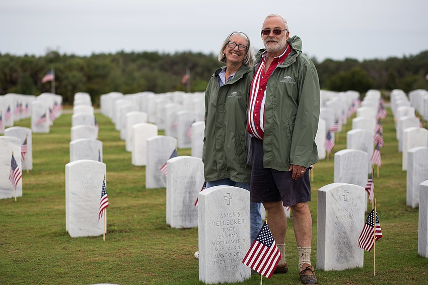 Marjorie and Jim Dellecker next to Jim's dad's stone.