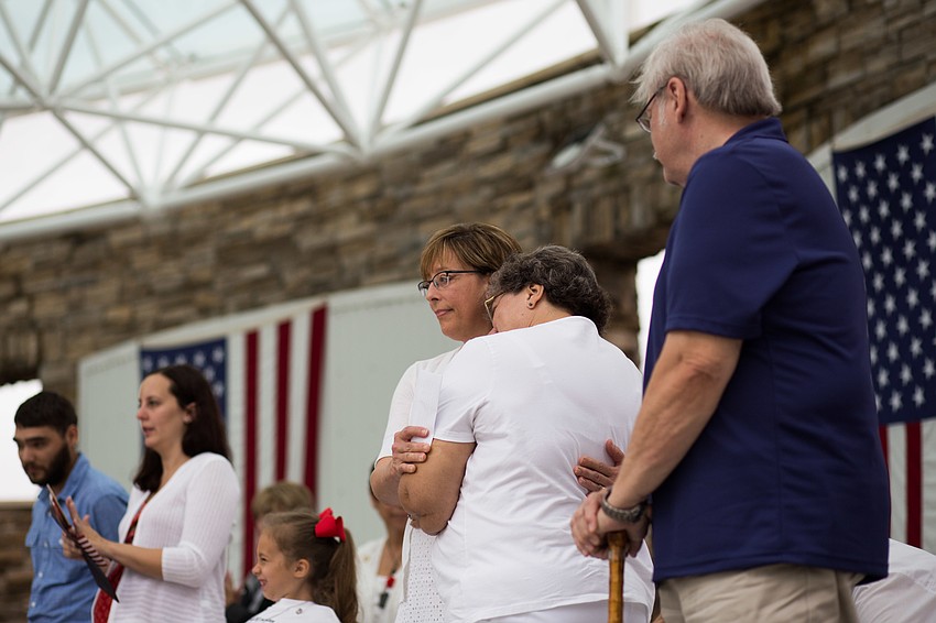 Kim Hayes gets a hug from a loved one after making her heartfelt speech.