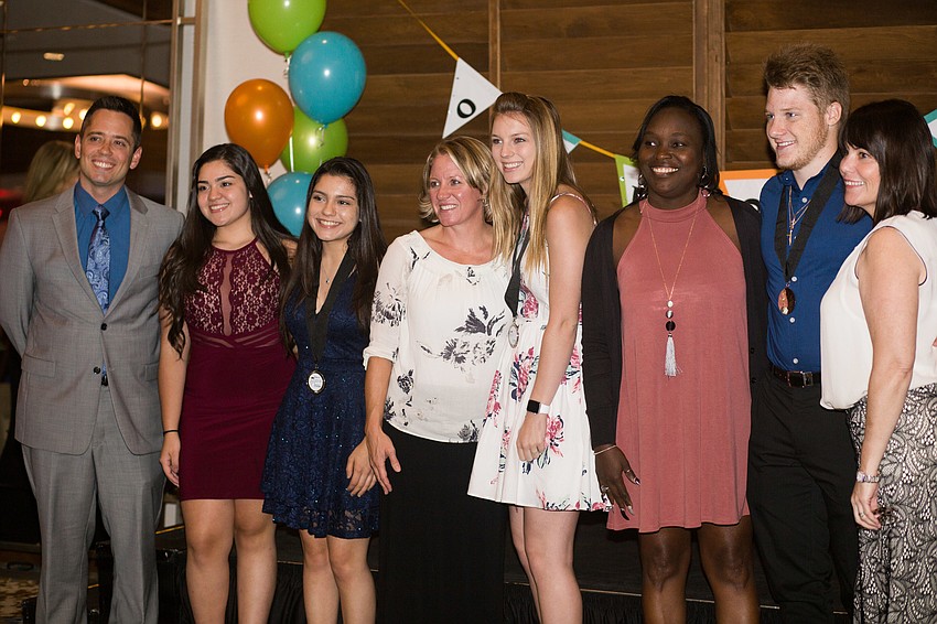 North Port High School graduates and their mentors pose for a photo.