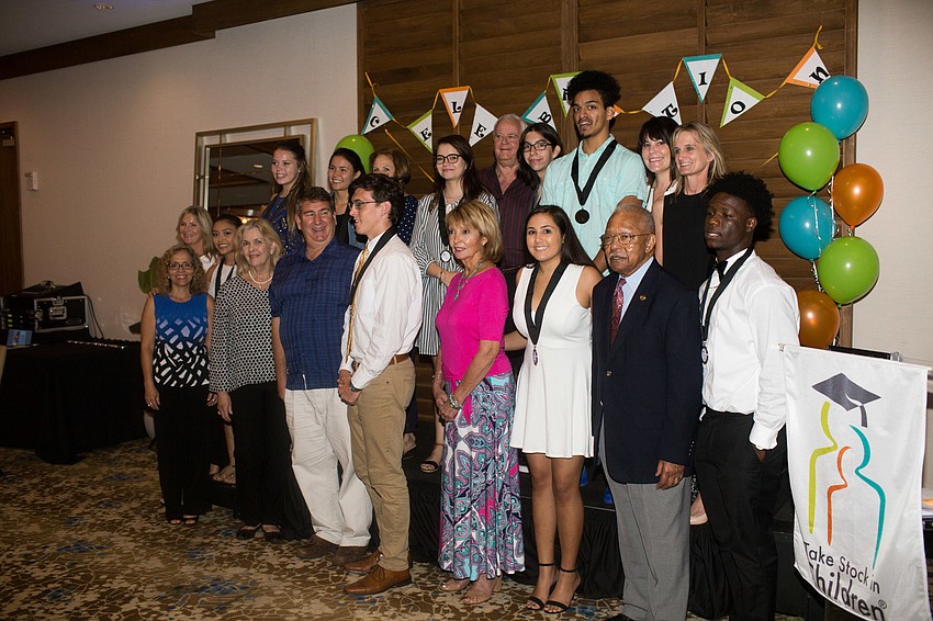 Riverview High School graduates and their mentors pose for a photo.