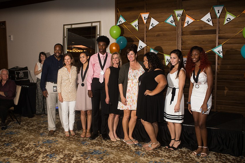 Sarasota High School graduates and their mentors pose for a photo.