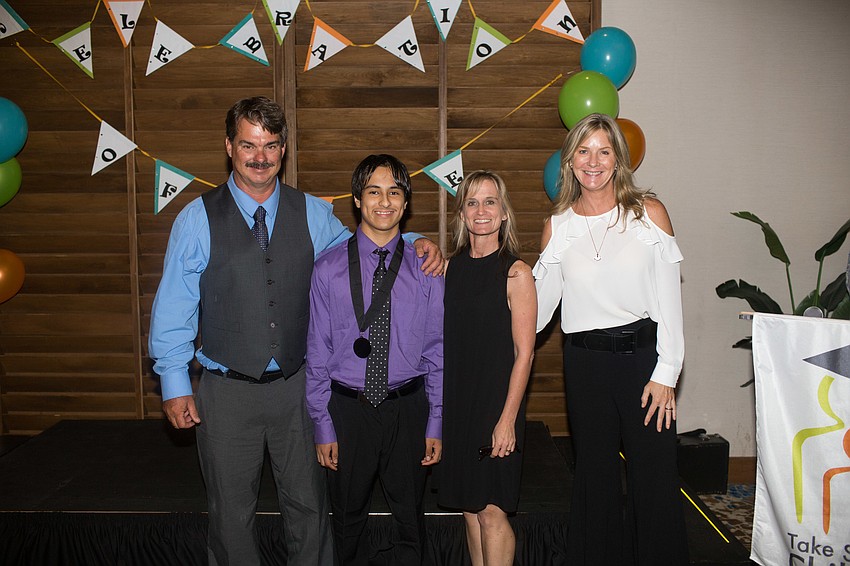 Matthew Jacobs, from Suncoast PolyTechnical High School,  poses for a photo with his mentors.