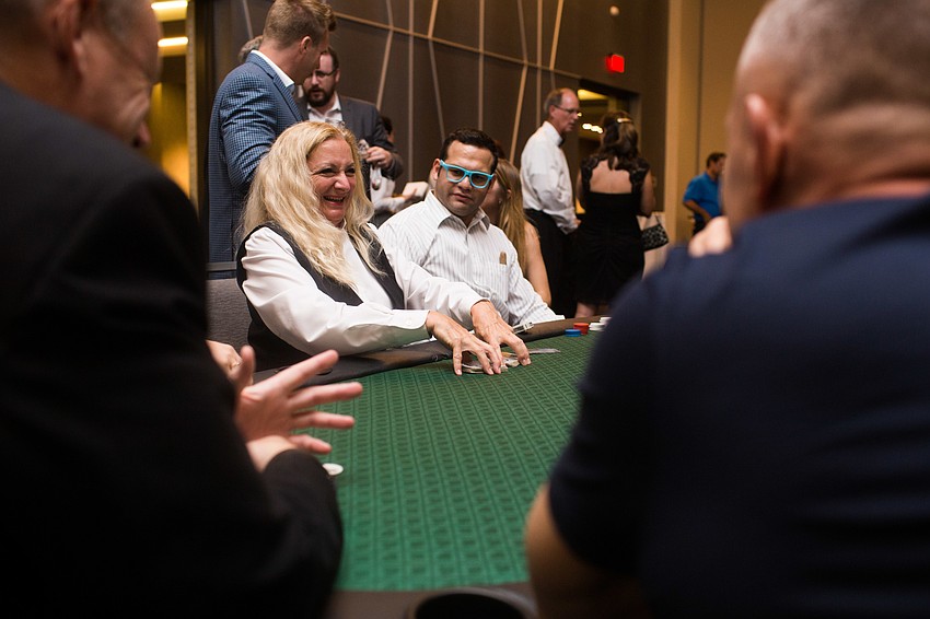 A group of guests play a game of poker.