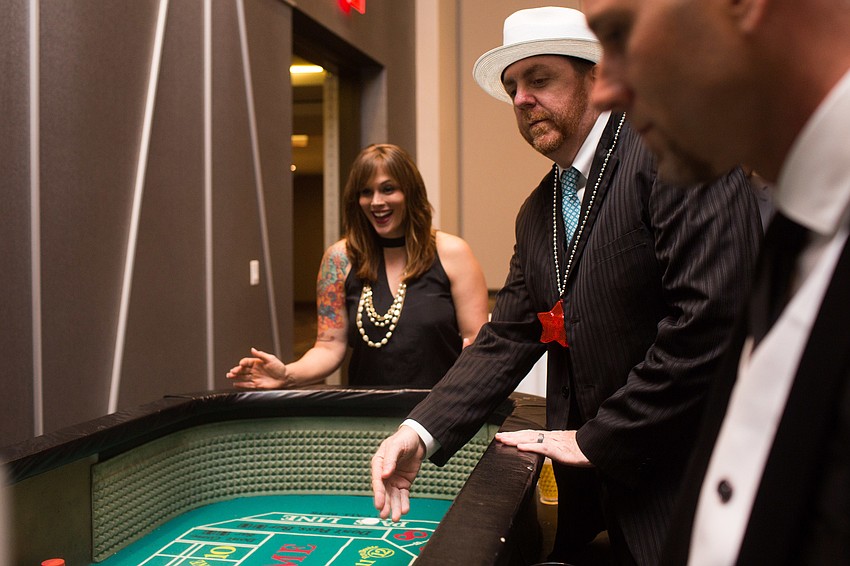 Rebecka Guilfoyle and Tony Moore watch as the dice are rolled.