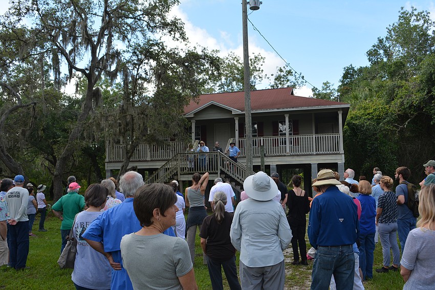 The porch of the home of the late Carl Bergstresser, who was a driving force behind Friends of Keep Woods, was used to address those who attended the celebration.