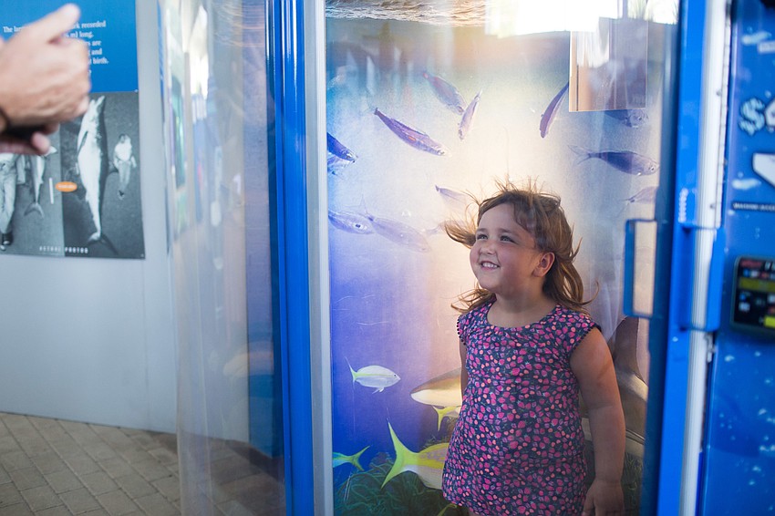 Gabby Stokes smiles for a photo in the hurricane simulator.