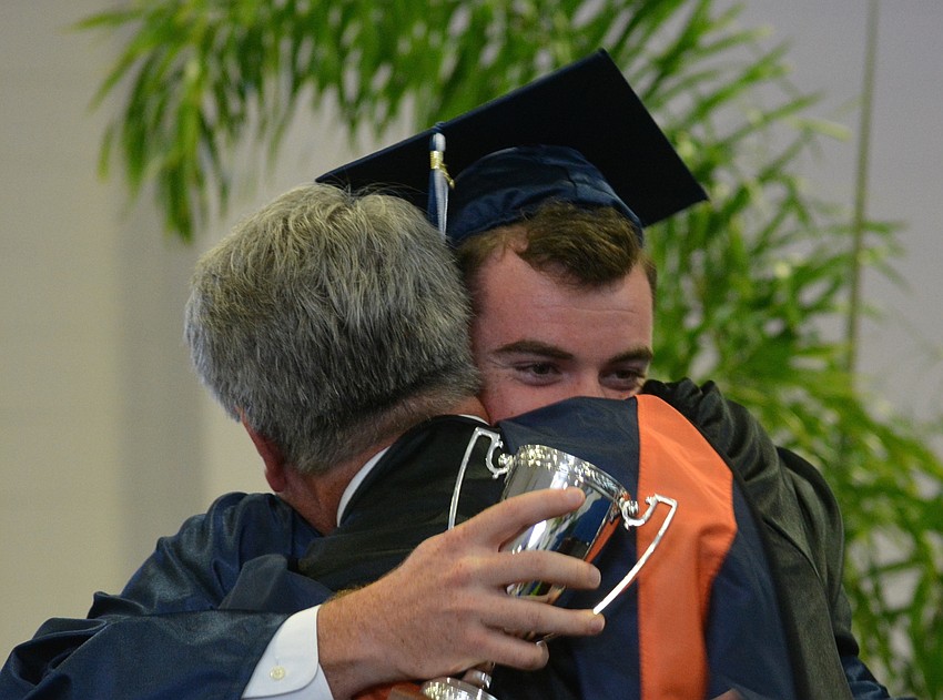 Gus Mahler embraces his dad, Head of School David Mahler, after he was awarded 