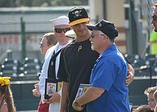 Marauders pitcher Jess Amedee visits with Mill Creek's Dave Daily, who was honored by the Marauders for his service.
