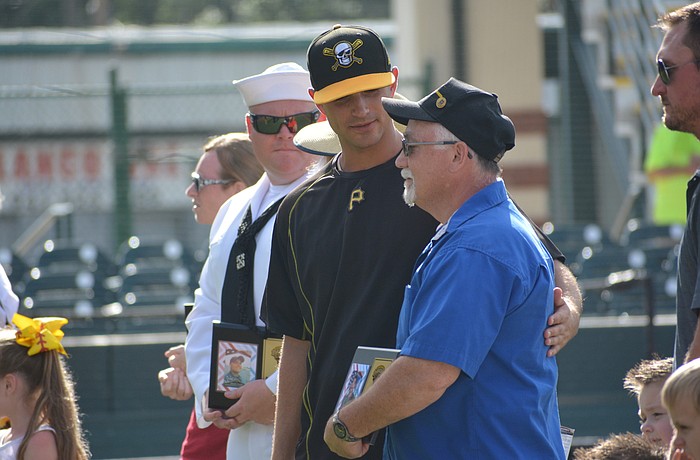Marauders pitcher Jess Amedee visits with Mill Creek's Dave Daily, who was honored by the Marauders for his service.