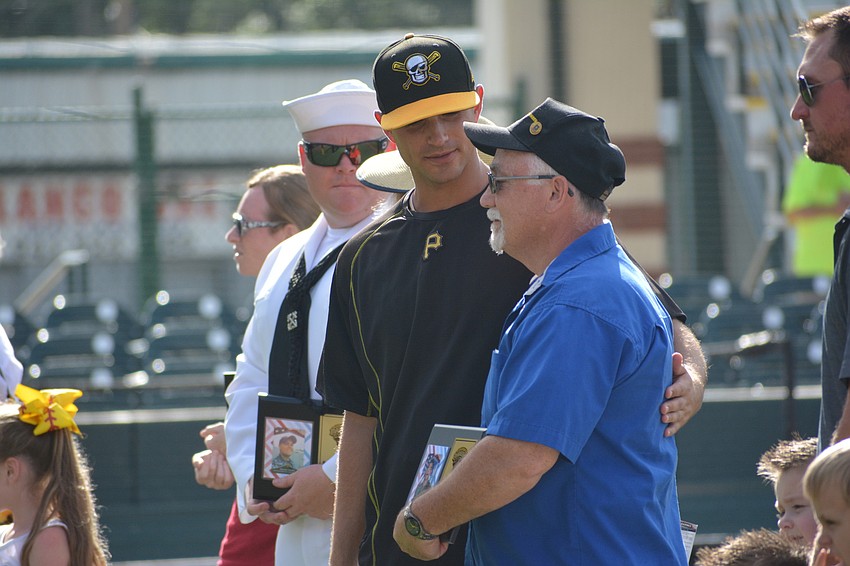 Marauders pitcher Jess Amedee visits with Mill Creek's Dave Daily, who was honored by the Marauders for his service.