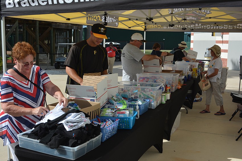 Marauders pitcher Jess Amedee works the donation line June 2 at Military Appreciation Night at LECOM Park.
