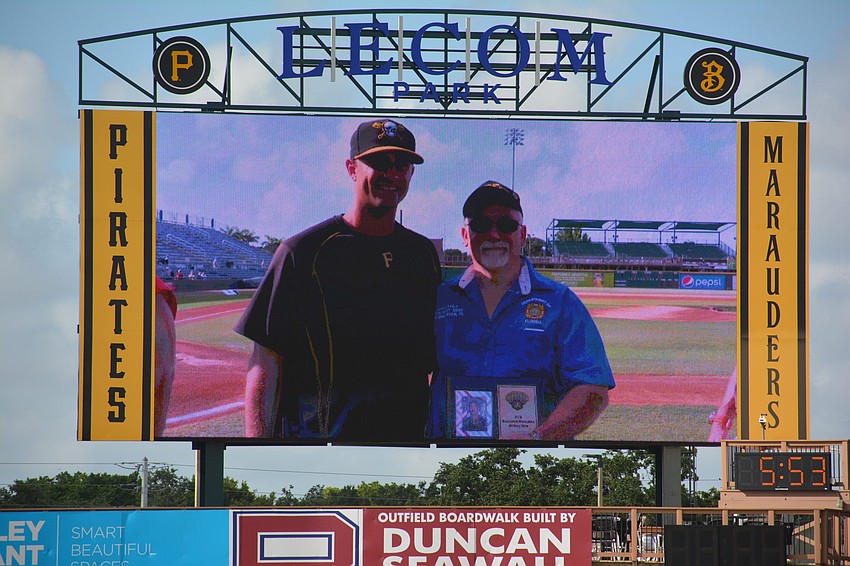 Marauders pitcher Jess Amedee hands Mill Creek's Dave Daily a plaque in honor of his service during Military Appreciation Night June 2 at LECOM Park.