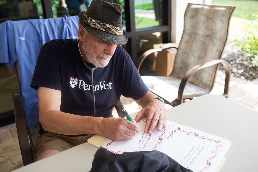 Dr. Hal Alterman wrote out certificates for the pets for being 