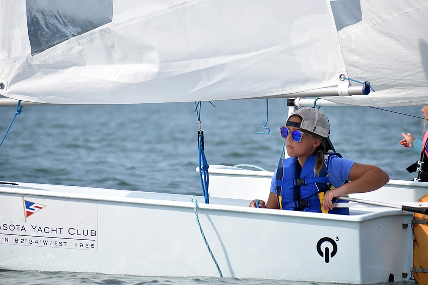 Avery Winslow steers her sailboat around Sarasota Bay.
