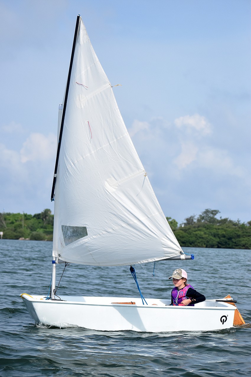 Mia Moxley steers her boat toward the John Ringling Causeway.