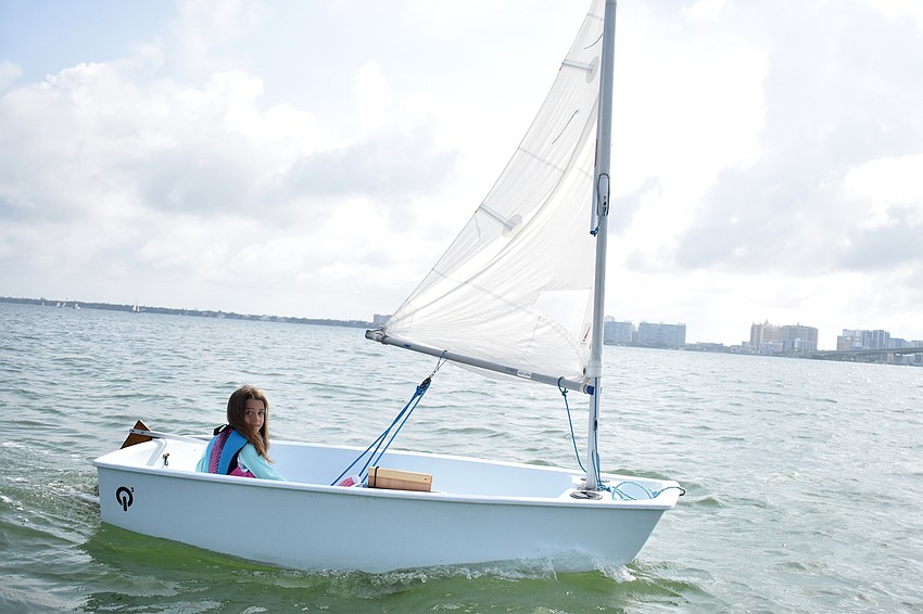 Abigail Cobb steers her boat toward the John Ringling Causeway.