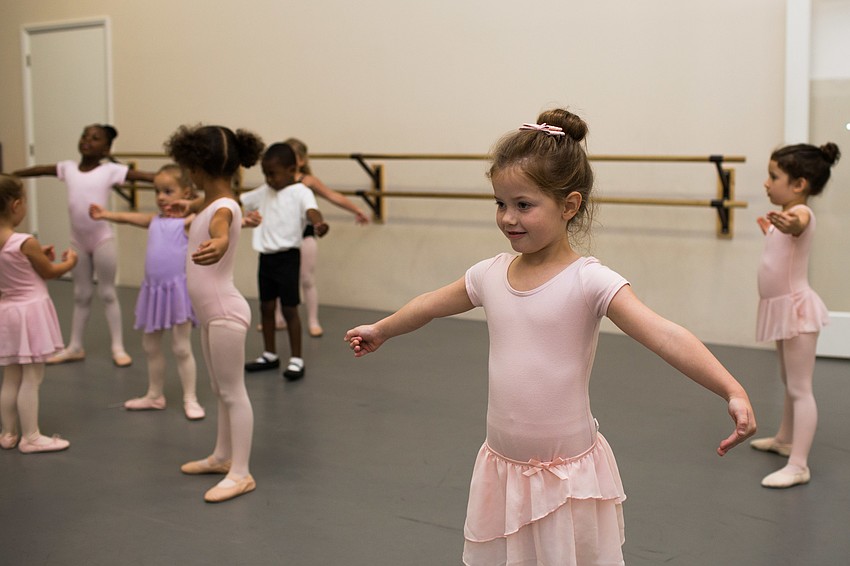 Addie Miller holds a first position pose.