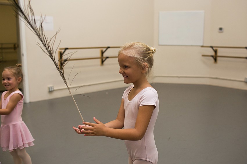 Eliana Elsasser balances the peacock feather.