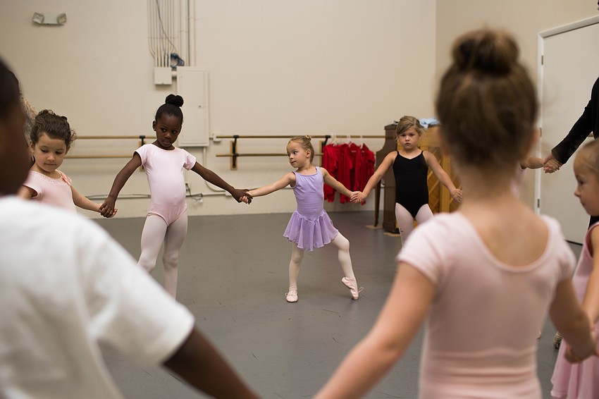 The dancers held hands in a circle before dancing together.
