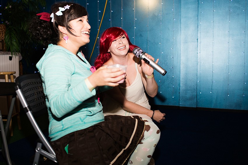 Riana Elliott and Jaqi Harris sing a song from 