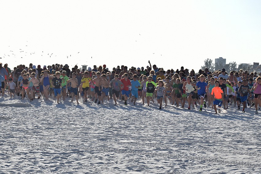Kids and some parents take off from the start line of the 1-mile run on June 5, 2018, at Siesta Beach.