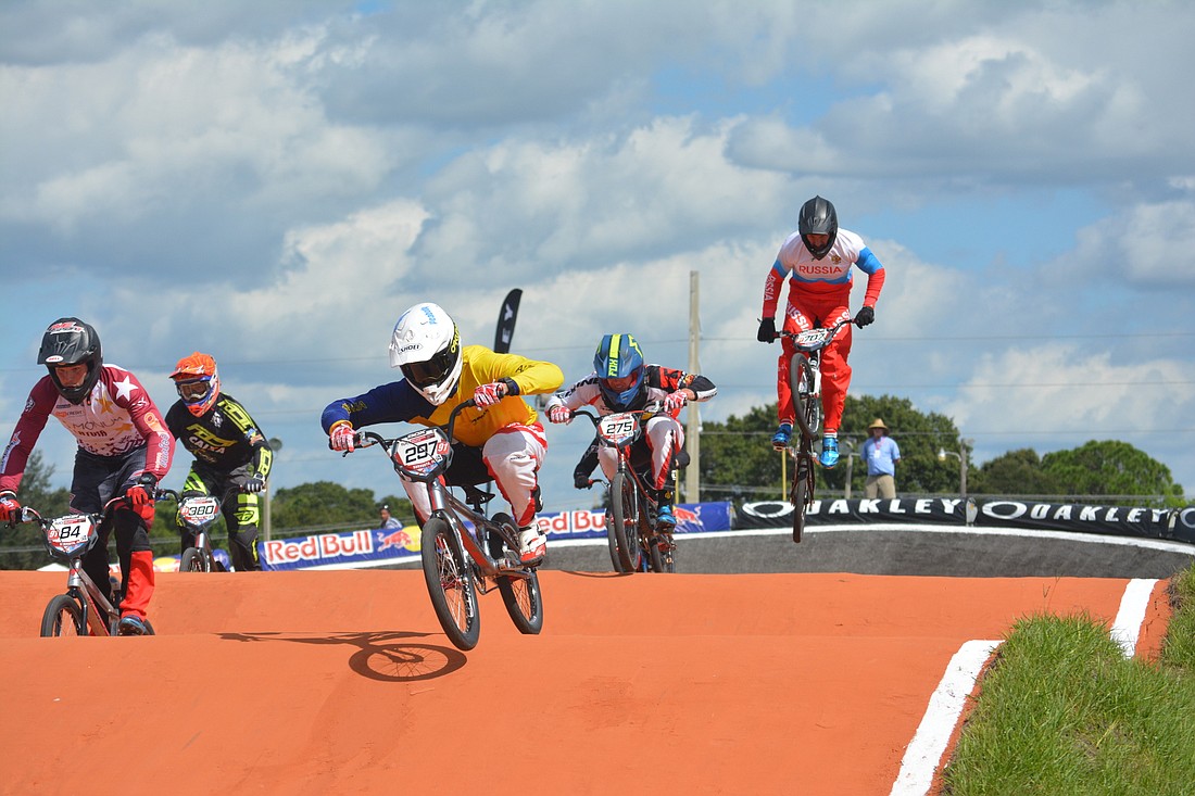 Riders test out the "rhythm section" of the renovated BMX track at the Youth Athletic Complex.