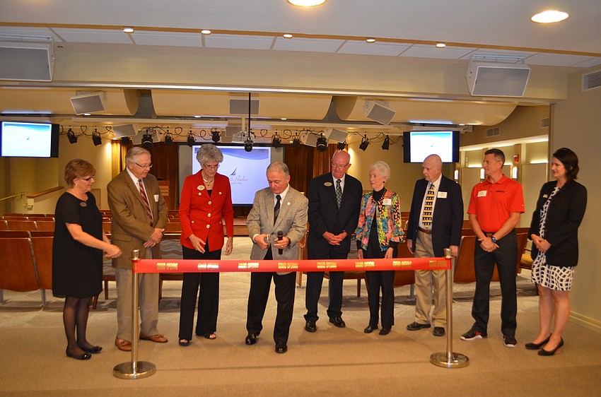 President and CEO of Plymouth Harbor Harry Hobson begins to cut the ribbon at Pilgrim Hall’s reopening.