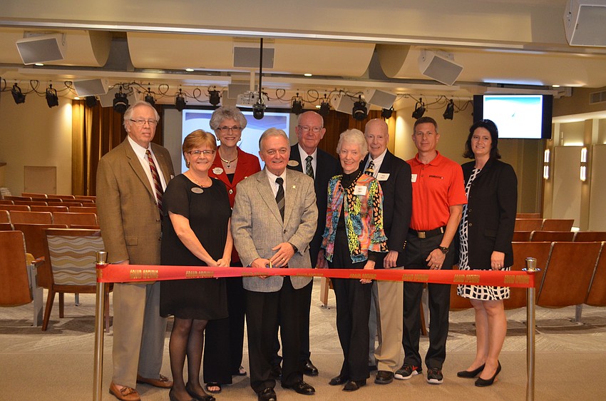 Tom Elliott, Becky Pazkowski, Sarah Pappas, Harry Hobson, Dick Sparrow, Barry and Phil Starr, Joe Carder and Laura Adcock stand at one of the entrances to the renovated Pilgrim Hall.