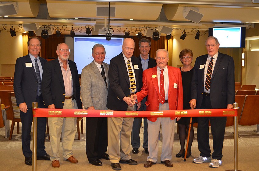 The Plymouth Harbor Foundation Board cuts a piece of the ribbon at the Pilgrim Hall reopening.