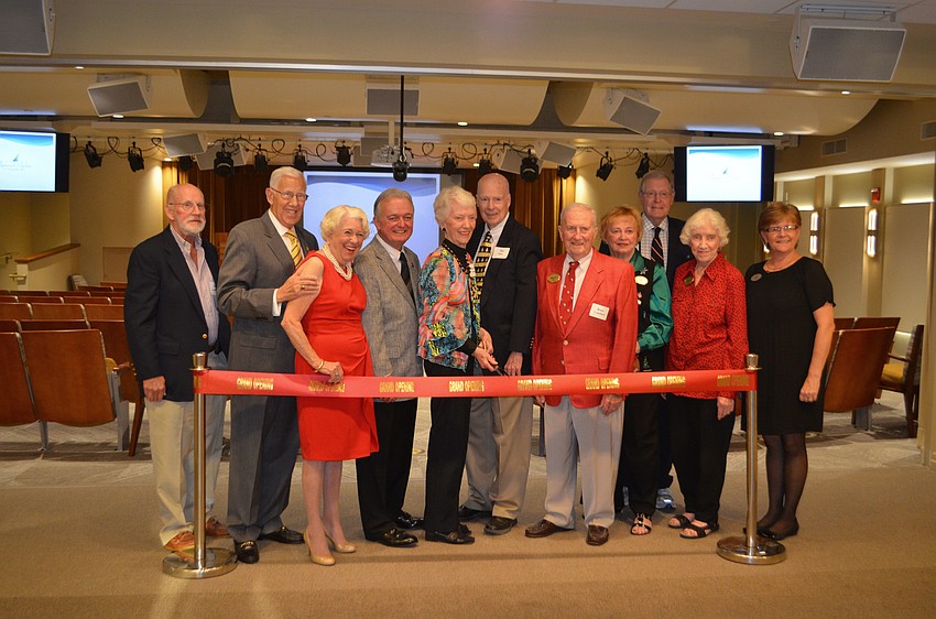 The campaign committee for the Pilgrim Hall renovation stands at one of the entrances to the new theater.